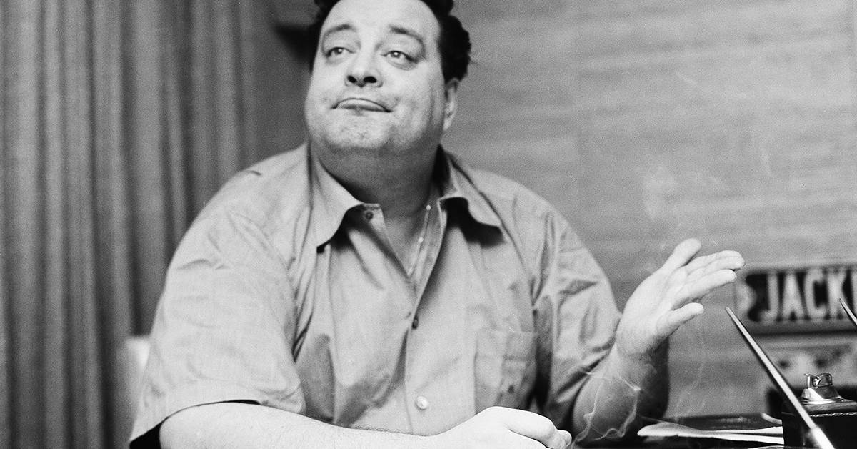 Comedian Jackie Gleason gestures at news conference, Jan. 28, 1956, New York. (AP Photo/John Rooney)