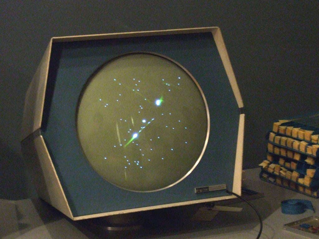 competitive gaming with 'Spacewar!' as players engage in intense space battles on the PDP-1 mainframe computer.
